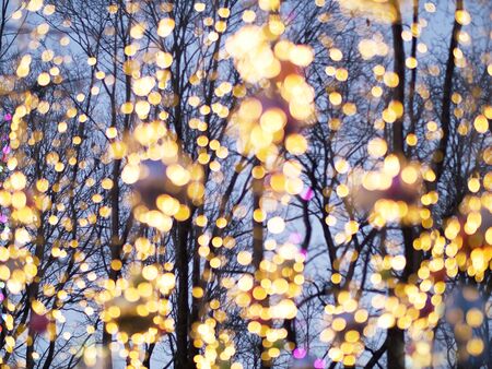 Multi-colored street lanterns blurred background, holiday concept.