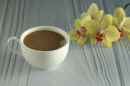 cup of coffee with orchids