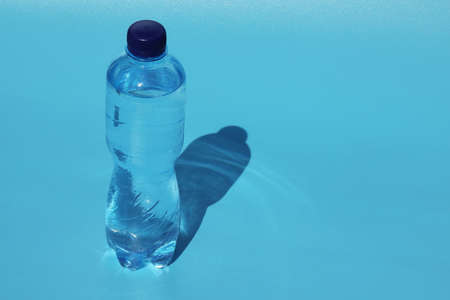 bottle of cold water on blue background