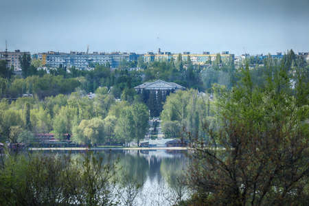 city view with trees and lake