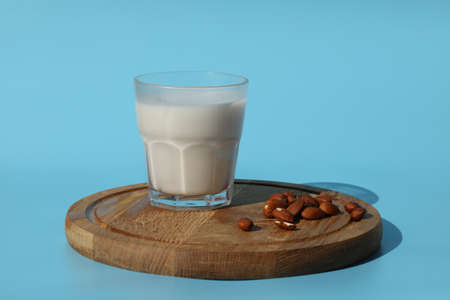 almond milk with almond nuts on wooden tableの写真素材