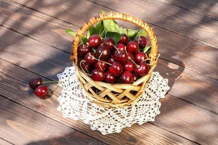 sweet cherry on wooden table in the gardenの写真素材