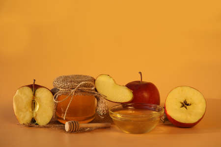 Red fresh apples with honey on yellow background with copy space. apple feastの写真素材