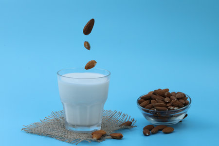 glass of almond milk on the blue background with copy spaceの写真素材