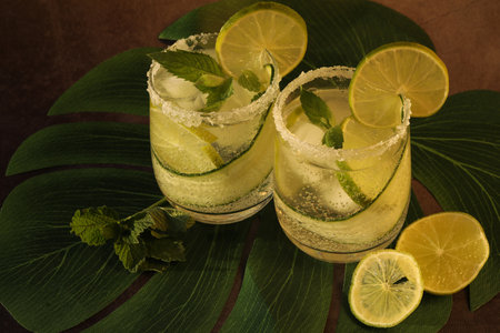 glasses with fresh cold lemonade with mint and limeの写真素材