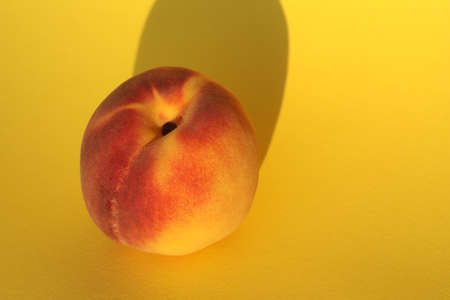 peaches on the yellow background with copy spaceの写真素材