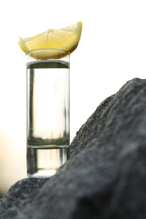 glass of alcohol drink with sky backgroundの写真素材