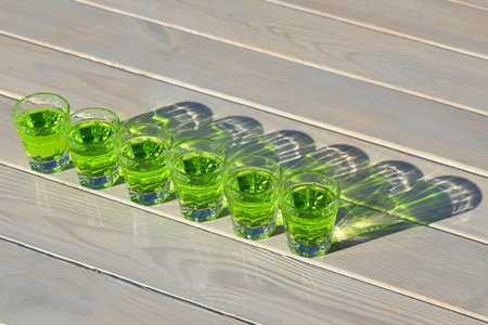 green absinthe drink pattern on the white wooden background with copy space