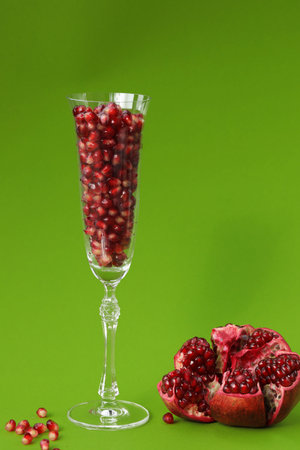pomegranate berries in a glass and pomegranateの写真素材