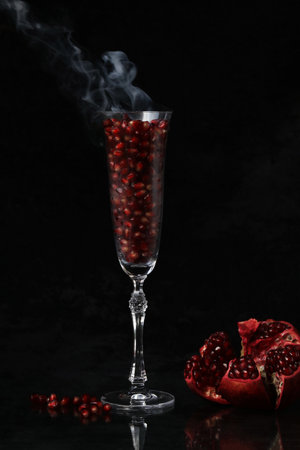 glass of red wine with smokeの写真素材