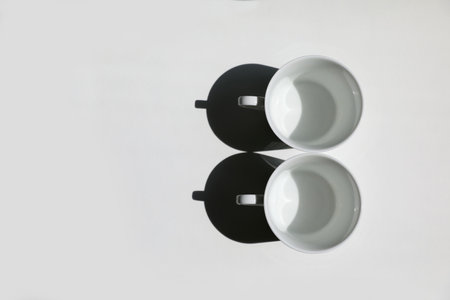 two white cups on the white background.の写真素材