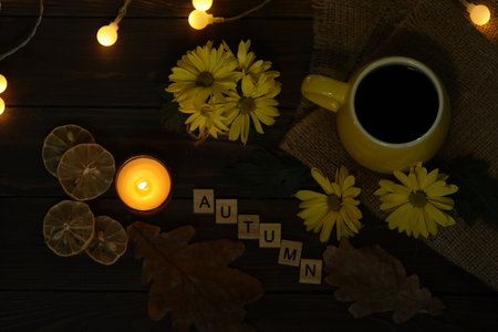 cup of coffee on the autumn background with leaves and flowers. Text Autumnの写真素材