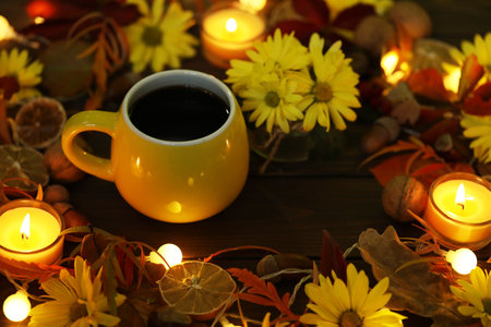 cup of coffee on the autumn background with leaves and flowers