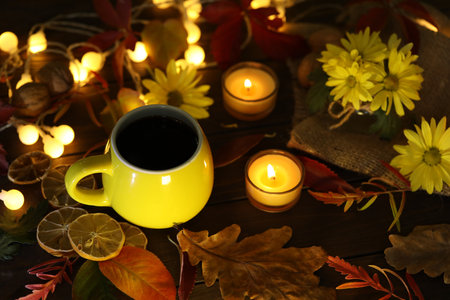 cup of coffee on the autumn background with leaves and flowersの写真素材