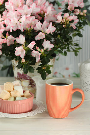 cup of coffee with marshmallow on white wooden tableの写真素材
