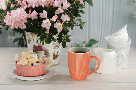 cup of coffee with marshmallow on white wooden tableの写真素材