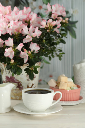 cup of coffee with marshmallow on white wooden tableの写真素材