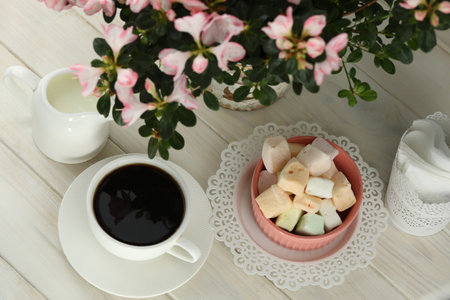 cup of coffee with marshmallow on white wooden tableの写真素材