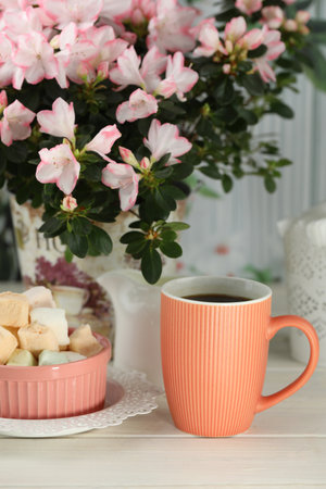 cup of coffee with marshmallow on white wooden tableの写真素材