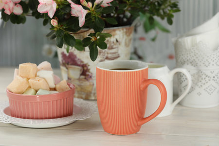cup of coffee with marshmallow on white wooden tableの写真素材