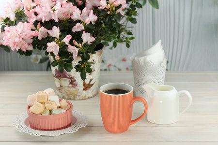 cup of coffee with marshmallow on white wooden tableの写真素材
