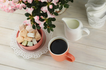 cup of coffee with marshmallow on white wooden tableの写真素材