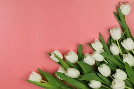 Beautiful bouquet of white tulip flowers with card on pink background, space for textの写真素材