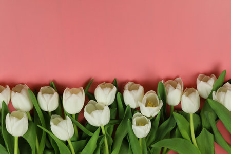 Beautiful bouquet of white tulip flowers with card on pink background, space for textの写真素材