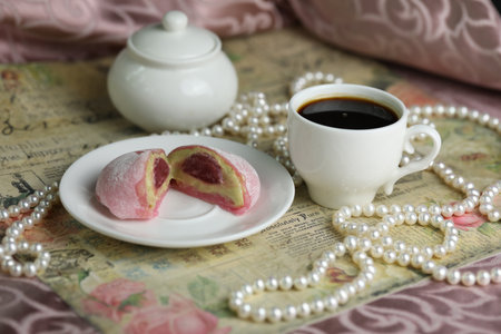 Colorful japanese sweets daifuku or mochi sliced. Sweets close up on the plate with cup of coffeeの写真素材