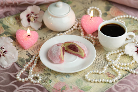 Colorful japanese sweets daifuku or mochi sliced. Sweets close up on the plate with cup of coffeeの写真素材