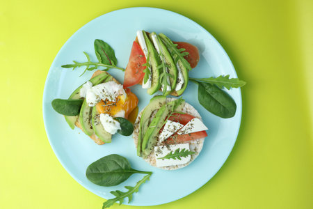 Diet toasts with cheese, salad, avocado, tomato and eggs. Healthy organic foodの写真素材
