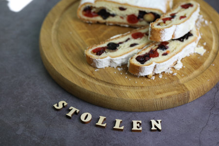 Sliced Chrismas stollen with powdered sugar and christmas decorationの写真素材