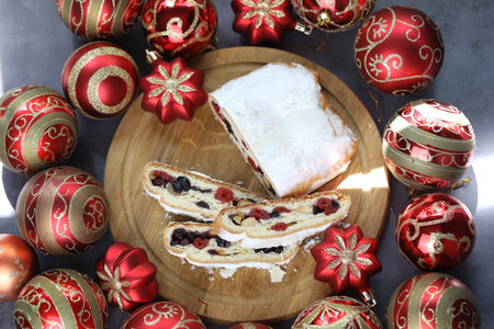 Sliced Chrismas stollen with powdered sugar and christmas decorationの写真素材