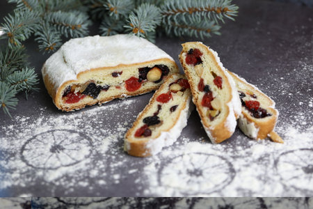 Sliced Chrismas stollen with powdered sugar and christmas decorationの写真素材