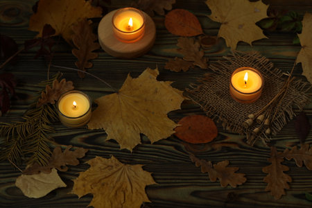 Autumn natural background with leaves and candles