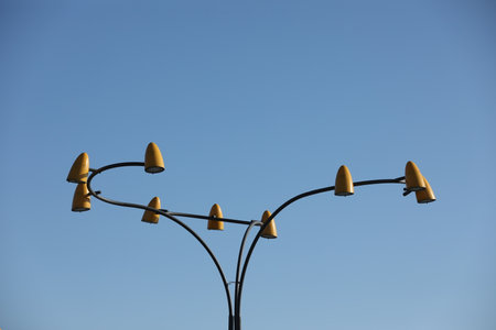 Original yellow street lamp with blue sky backgroundの写真素材