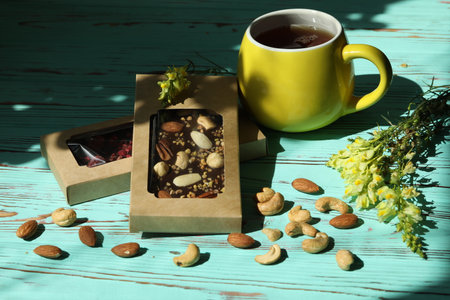 Homemade chocolate with cup of coffee and nutsの写真素材
