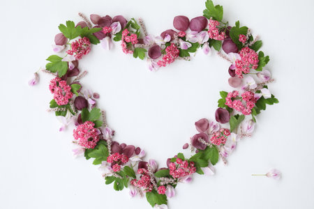 Heartshaped botanical frame with copy space. Floral background with place for text