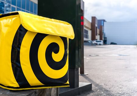 Yellow food delivery box standing outside.の写真素材