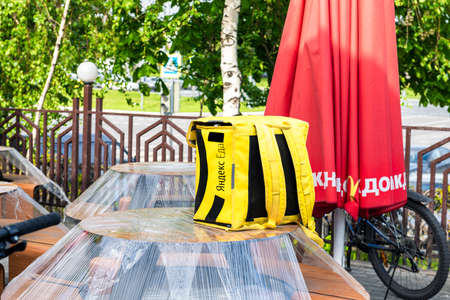 Moscow, Russia-May, 2020: McDonalds restaurant closed to visitors due to coronavirus. Food delivery bikes and boxes parked outside. Inscription on boxes, translation: Yandex foodのeditorial素材