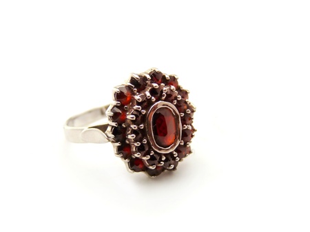 Silver ring with garnet isolated on a white background の写真素材
