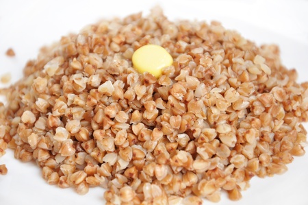 Appetizing crumbly buckwheat with butter on white backgroundの写真素材