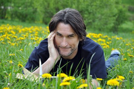 A man reads a book in the parkの写真素材