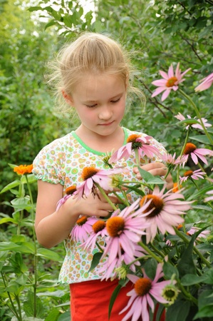 Beautiful girl standing in the flowersの写真素材