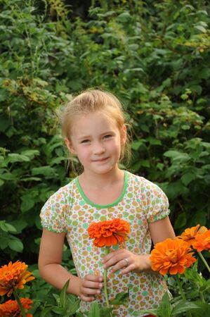 Beautiful girl standing in the flowersの写真素材