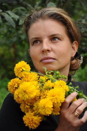 Portrait of a woman with yellow flowersの写真素材