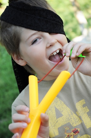 A boy plays with a left-handed catapultの写真素材
