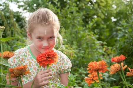 Portrait of a beautiful girl on the background of flowersの写真素材
