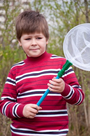 Boy with a butterfly net for catching butterfliesの写真素材