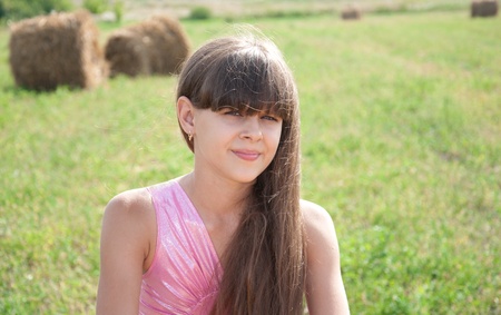 Portrait of a beautiful dark-haired girl in a fieldの写真素材